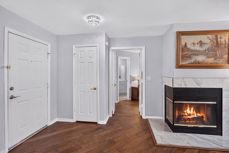 Entry hallway with front door and fireplace in view at 10150 Belle Rive Blvd, Jacksonville, FL
