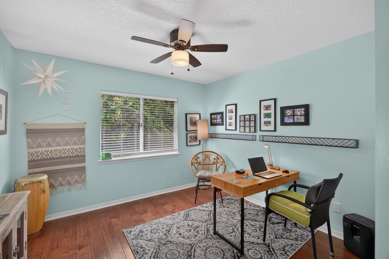Bedroom used as office with desk and light blue walls at 1820 Burgess Hill Dr E, Jacksonville, FL