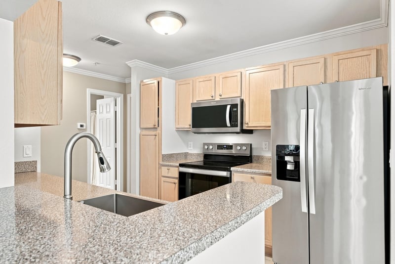 Kitchen with granite counters and stainless refrigerator at 7800 Point Meadows Dr, Jacksonville, FL 32256
