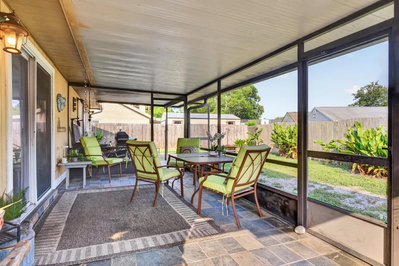 Screened porch with table and chairs at 13020 Medford Ln, Jacksonville, FL 32225