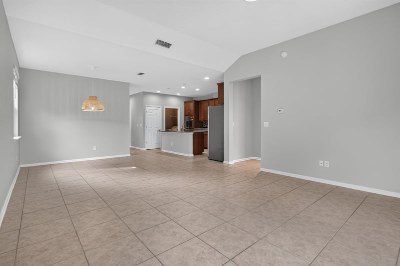 Open living and kitchen area with vaulted ceiling at 13685 Goodson Pl, Jacksonville, FL 32226
