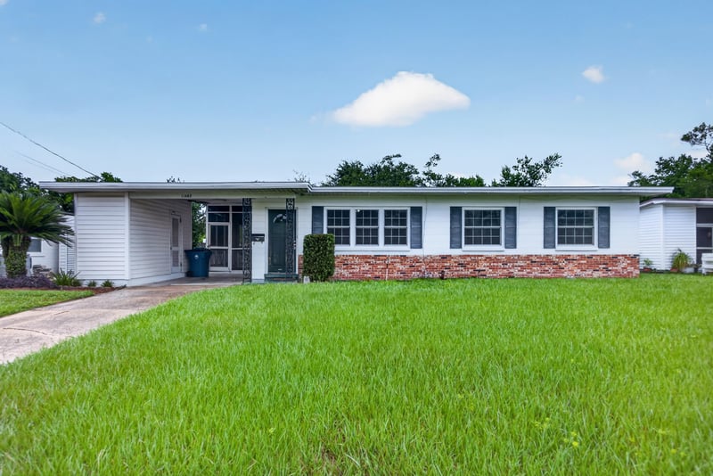 Front exterior view of white brick ranch home at 11462 Elane Dr, Jacksonville, FL