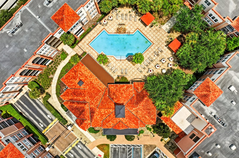 Aerial view of the pool courtyard and red tile roofs in Jacksonville, FL