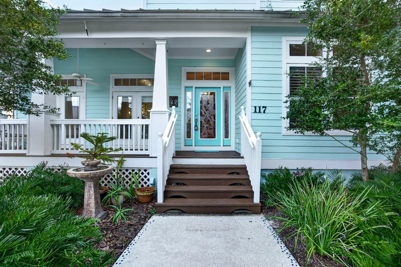 Front porch stairs and teal entry door at 117 Island Cottage Way, St. Augustine, FL 32080