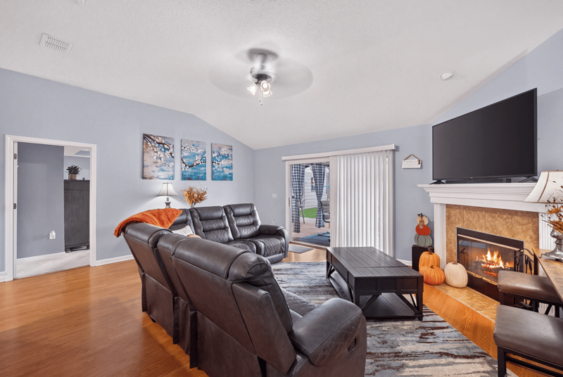 Family room with stone fireplace and leather recliners at 3112 Silverado Cir, Green Cove Springs, FL 32043