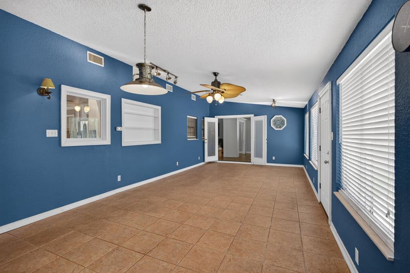 Lounge room corner with windows and track lighting at 5843 Ovella Rd, Jacksonville, FL 32244
