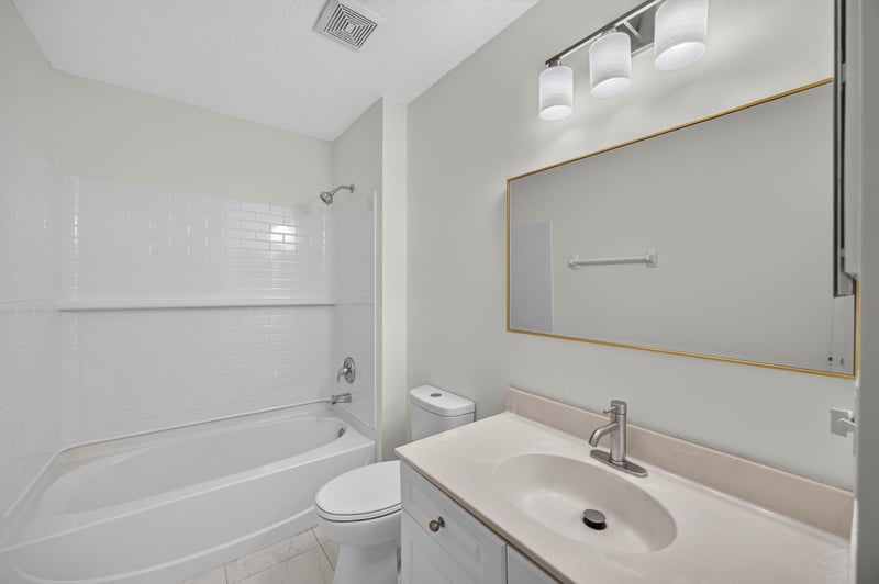 Bathroom with tub-shower combo and vanity at 706 Bonaparte Dr, Jacksonville, FL 32218