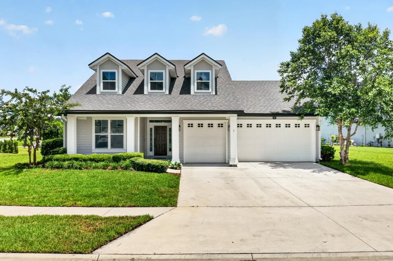 Front exterior with dormer windows and attached garage at 53 Lumen Ct, St. Augustine, FL 32095
