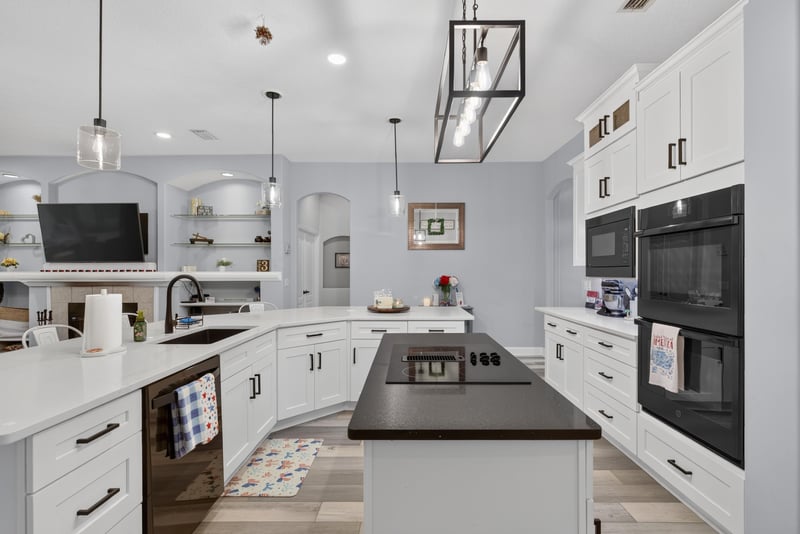 Kitchen with double wall ovens and TV at 2304 Spring Hill Ct, Orange Park, FL