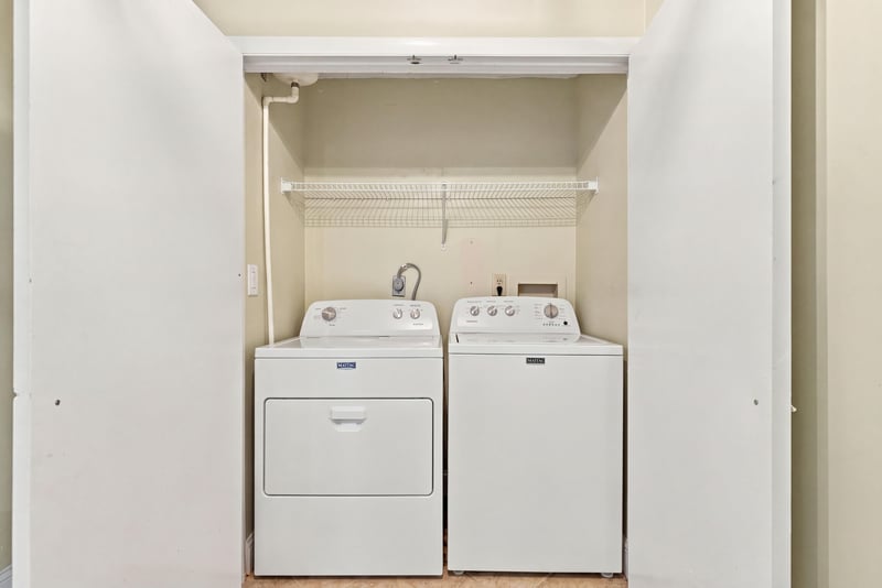 Laundry closet with stacked washer and dryer at 805 Spinnakers Reach Dr, Ponte Vedra Beach, FL 32082