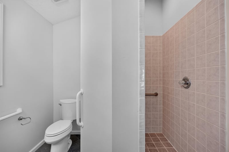 Hall bath shower with tile surround at 11675 Magnolia Estates Rd, Jacksonville, FL 32223