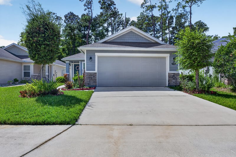 Front exterior with driveway and landscaping at 7118 Preston Pnes Trl, Jacksonville, FL