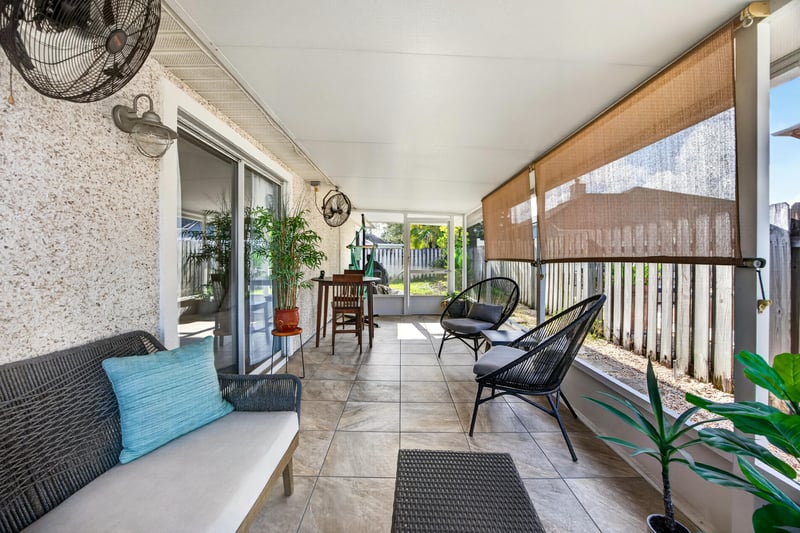 Screened porch with seating and ceiling fan at 12825 Kelsey Island Dr, Jacksonville, FL 32224