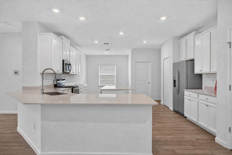 Kitchen with island and white cabinets at 9905 Ansley Lake Dr, Jacksonville, FL