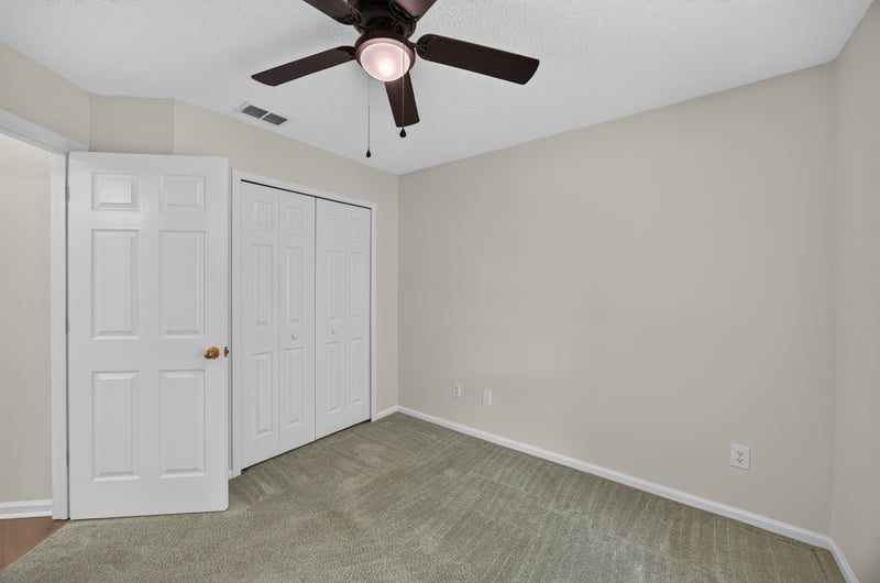 Secondary bedroom with closet doors at 605 N Covered Bridge Rd, Jacksonville, FL