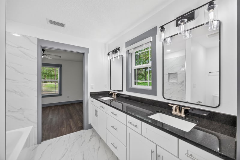 Bathroom with dual vanity and mirrors at 4800 Acacia St, Middleburg, FL 32068