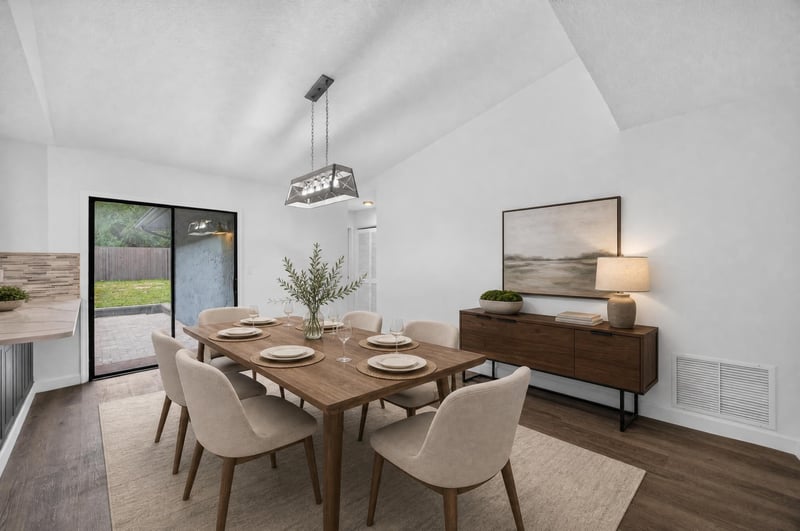 Dining area staged with table, chairs and pendant light at 551 Deltona Blvd, St. Augustine, FL 32086
