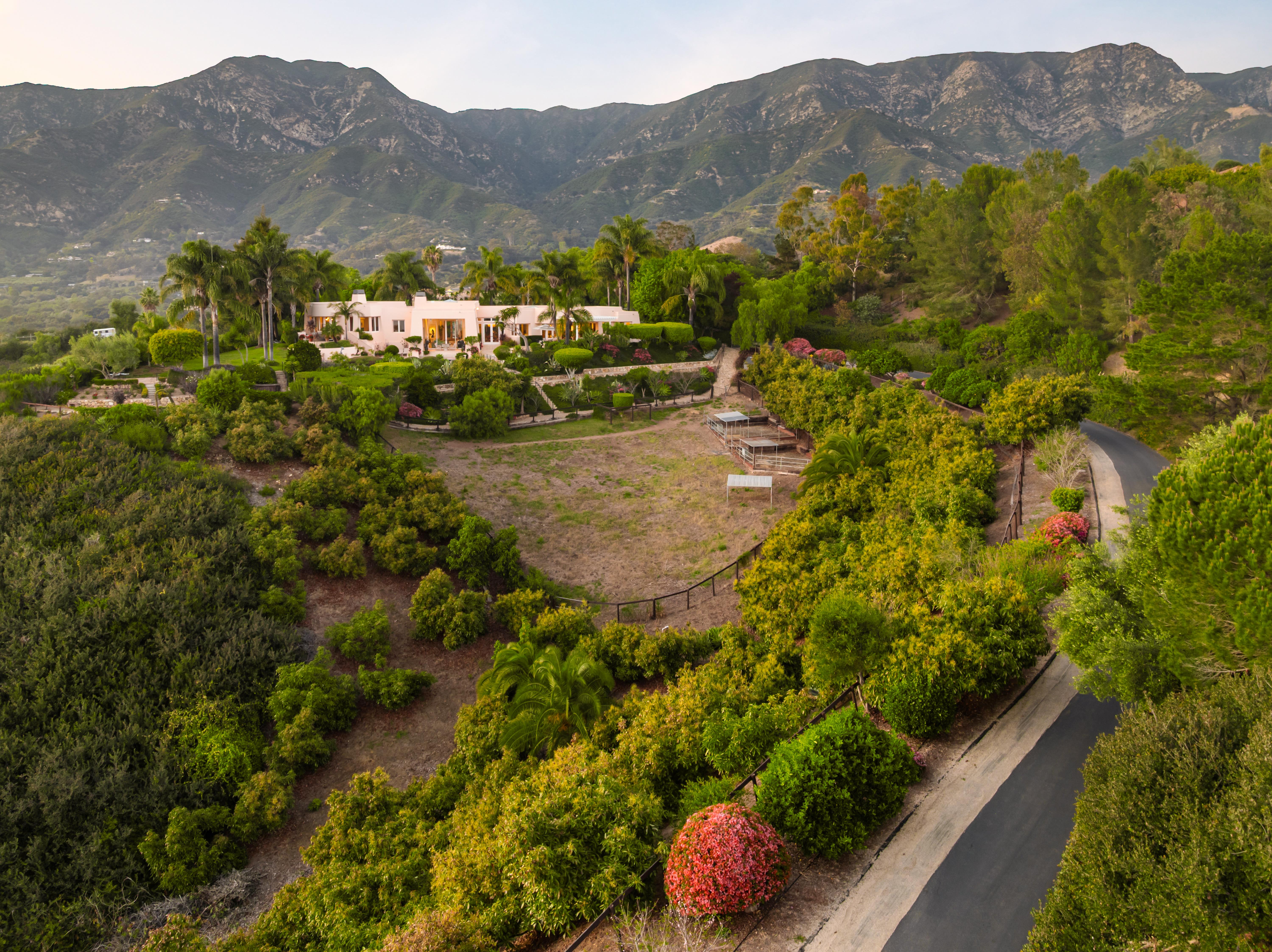 Aerial drone photography of 11 Hunt Drive Santa Barbara CA showcasing roofline and Montecito foothills beyond by VirTour Media