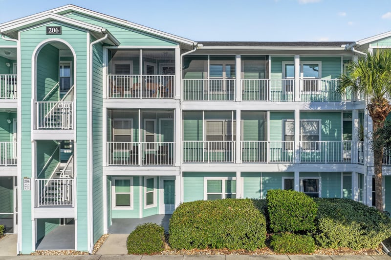 Front exterior corner of the building showing covered balconies and stairs at 206 16th St, St. Augustine, FL 32080