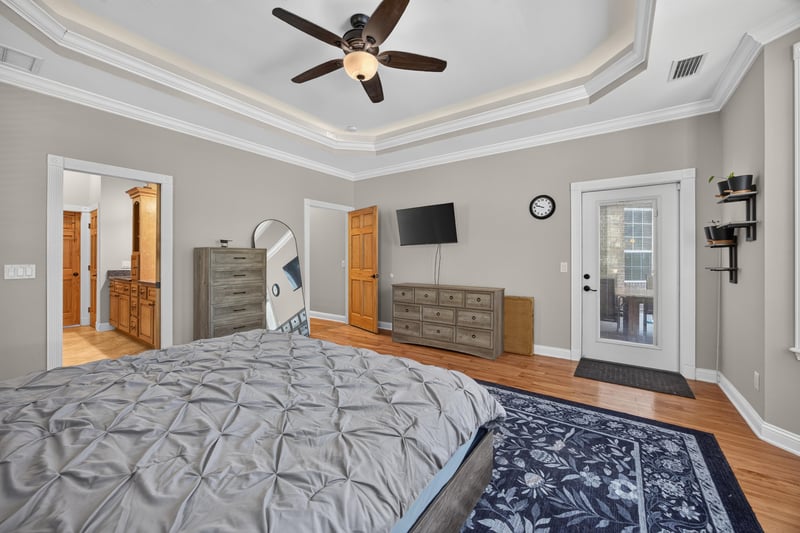 Primary bedroom with dresser and hardwood floors at 1735 Hagans Ridge Ct