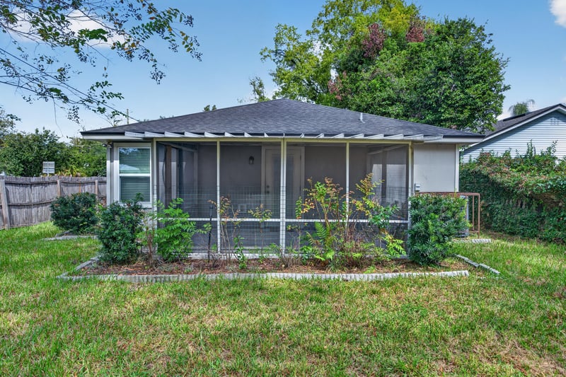 Back exterior view of screened porch and yard at 1002 Ingleside Ave, Jacksonville, FL 32205