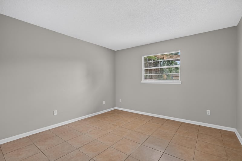 Bedroom with tile floor and window at 1040 Willow Cove Ct E, Jacksonville, FL 32233