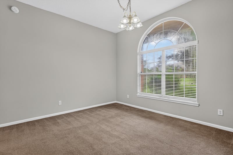 Empty room with arched window and carpet at 11669 Collins Creek Dr, Jacksonville, FL 32258