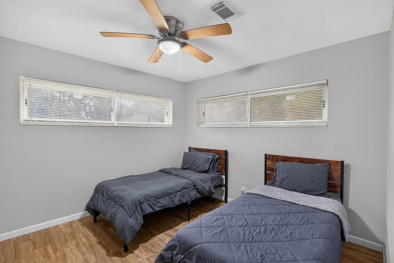 Bedroom with twin beds and ceiling fan at 9506 Harriet Ave, Jacksonville, FL 32208
