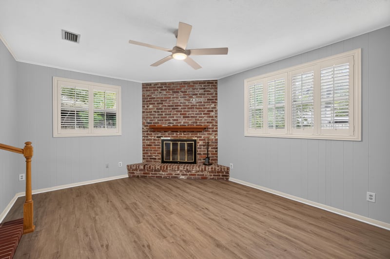 Family room with brick fireplace and plantation shutters at 1834 Memory Ln, Jacksonville, FL
