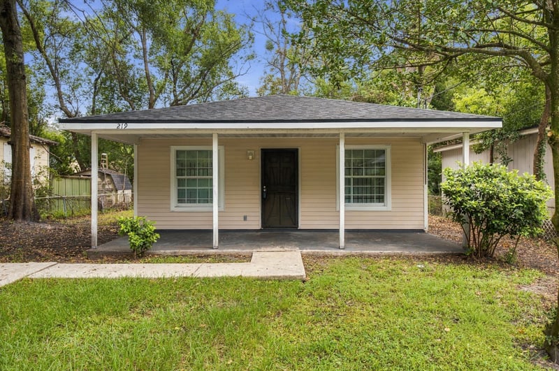 Front exterior with covered porch and concrete walkway at 219 Shortreed St, Jacksonville, FL 32254