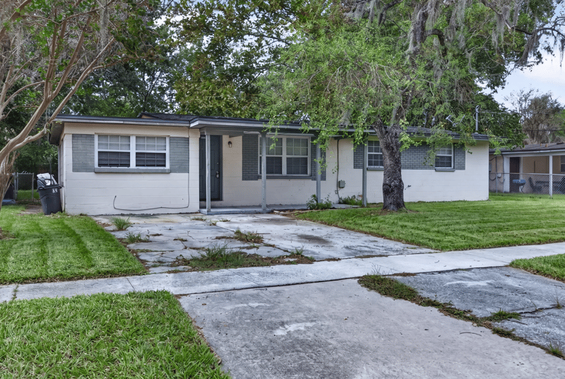Front exterior with driveway and lawn at 5812 Tampico Rd, Jacksonville, FL 32244