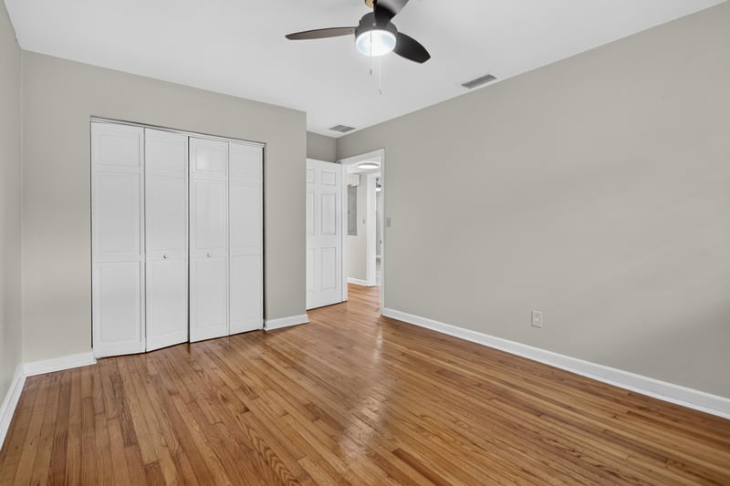 Hallway with wood floors and closet doors at 217 Baisden Rd, Jacksonville, FL 32218