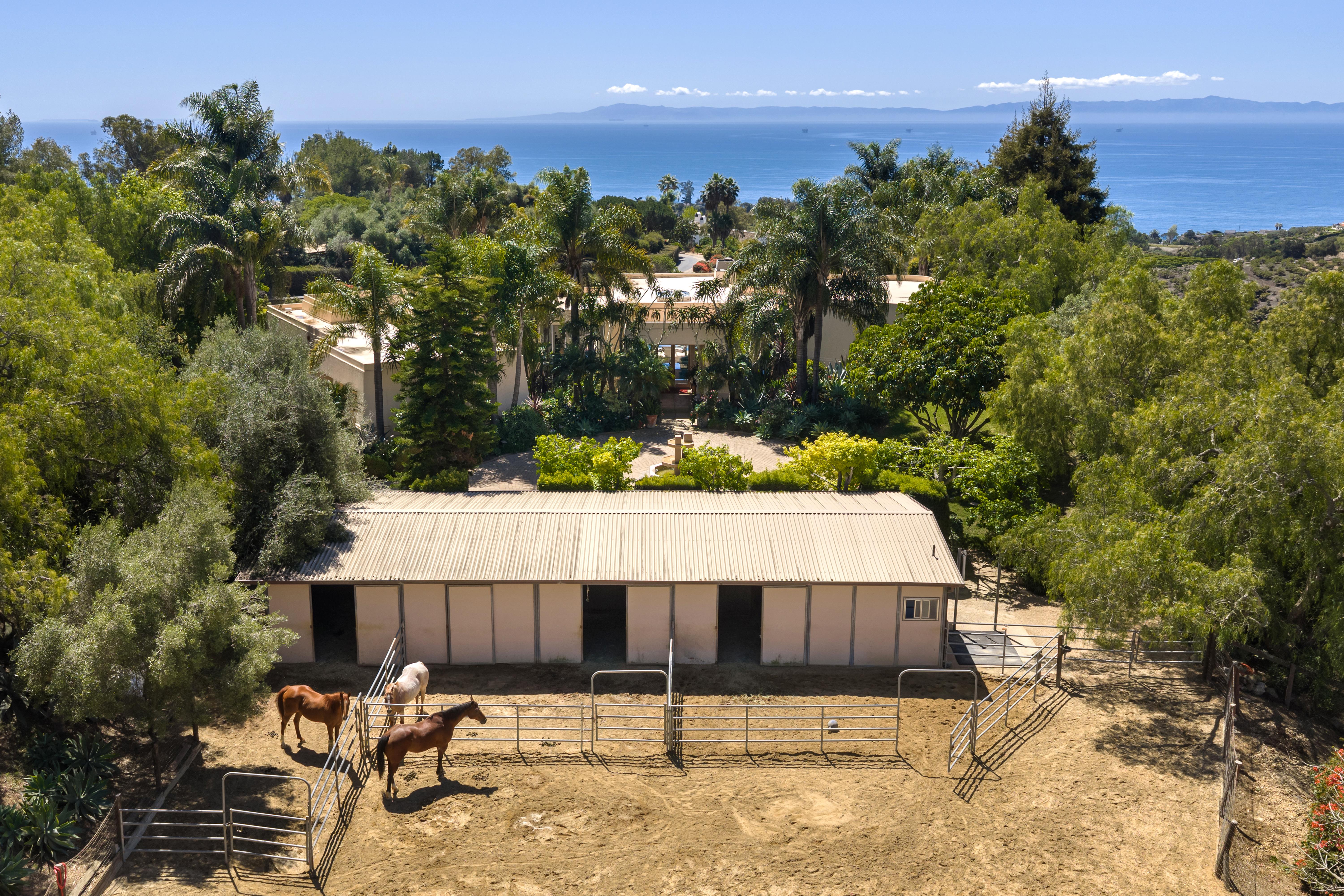 Aerial drone photography of 11 Hunt Drive Santa Barbara CA showcasing roofline and Montecito foothills beyond by VirTour Media