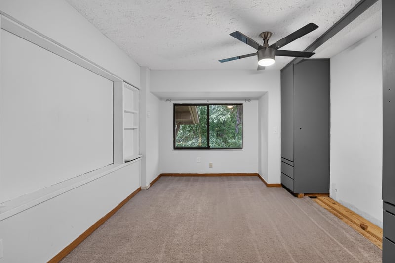 Bedroom with window and reach-in closet at 2910 Ravines Rd, Middleburg, FL 32068