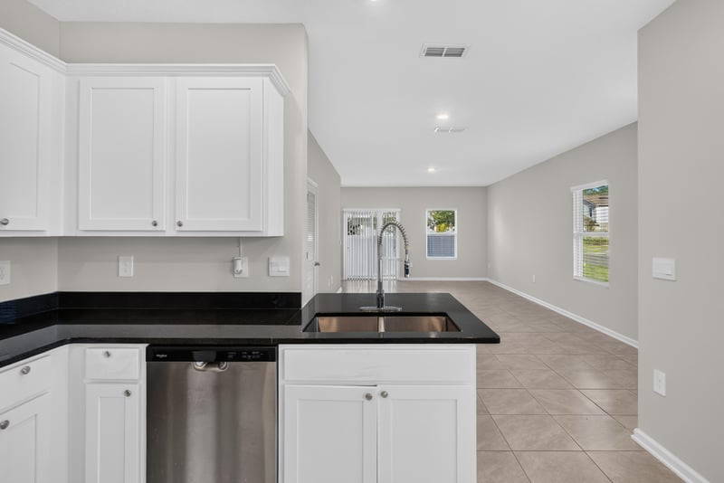 Kitchen sink area with black countertop at 4024 Bay Hawk Ct, Jacksonville, FL