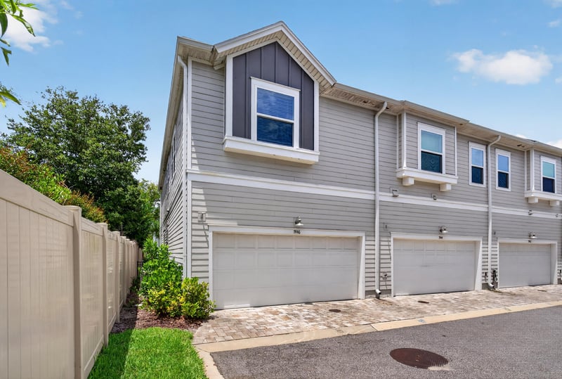 Side exterior with garage doors at 7446 Loggerhead Ct, Jacksonville, FL 32256