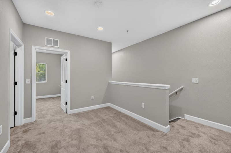 Upstairs hallway with stair railing at 9745 Touchton Rd, Jacksonville, FL 32246