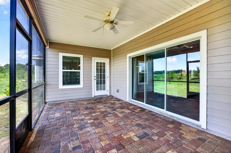 Screened lanai with sliding glass doors at 9942 Lovage Ln, Jacksonville, FL 32219