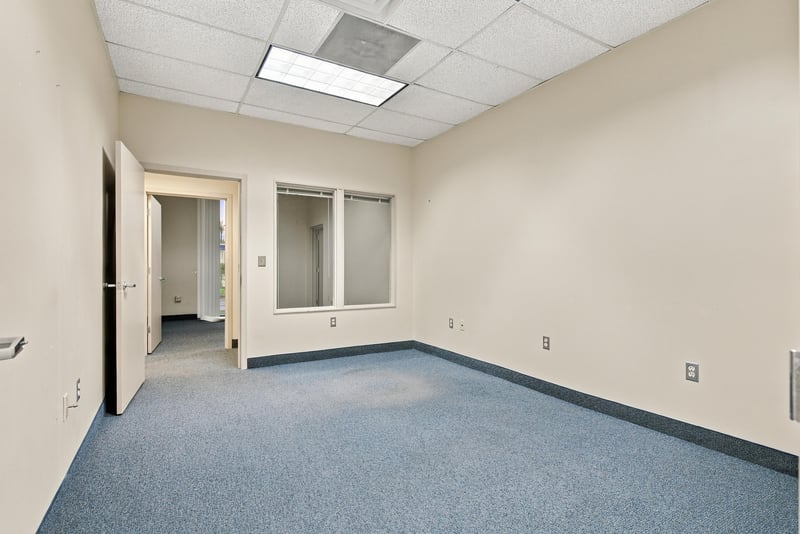 Empty carpeted office room at 101 Scholars Wy