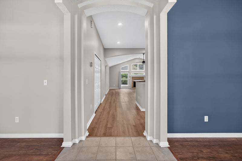 Hallway with wood flooring leading to living areas at 1955 GUARDED Way, Fleming Island, FL 32003