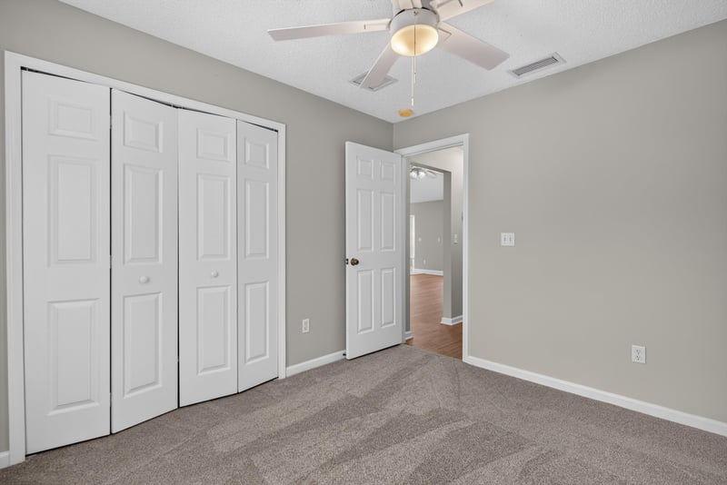 Bedroom with closet doors at 12949 Chets Creek Dr S, Jacksonville, FL 32224