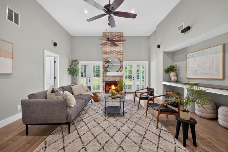 Living room with fireplace and French doors at 1161 Whispering Pines Rd, Jacksonville, FL 32259