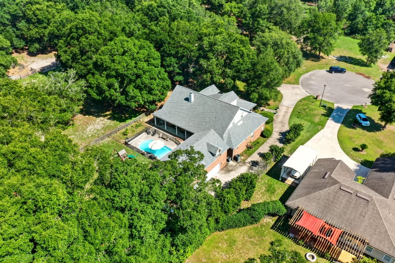 Aerial view of the property with pool and trees at 1735 Hagans Ridge Ct