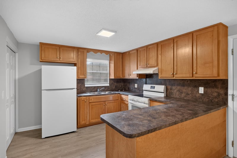 Kitchen with wood cabinets and white refrigerator at 1435 Undine Ave, Jacksonville, FL