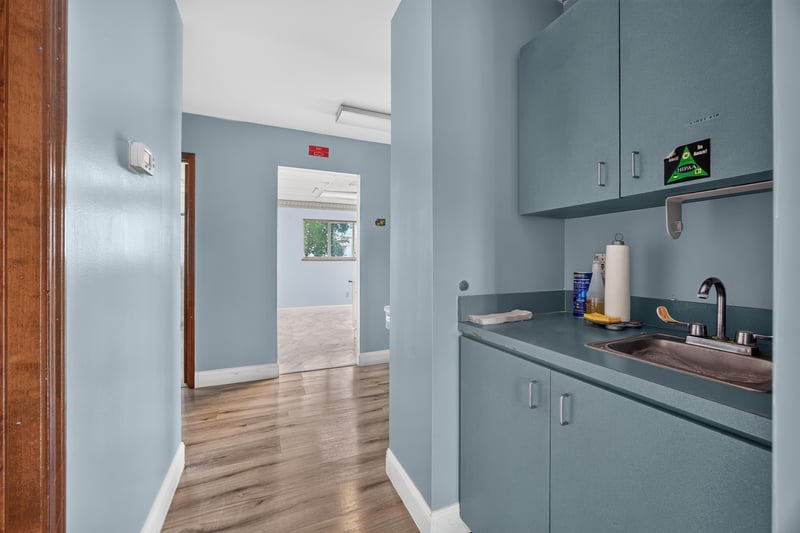 Hallway area with sink counter and wood-look floor at 1543 Kingsley Ave #19, Orange Park, FL 32073