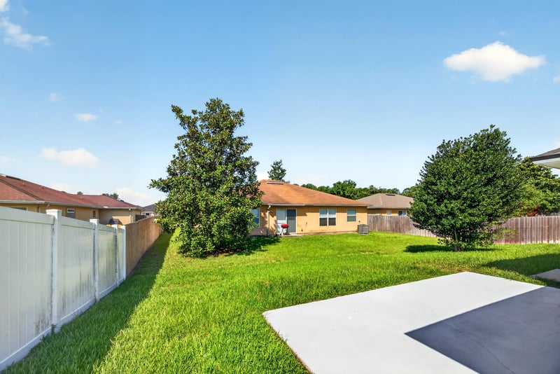 Backyard patio slab and fenced lawn at 2282 Justin Lake Dr, Jacksonville, FL