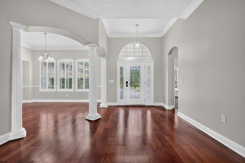Foyer view toward glass front door and columns at 4109 Eagle Landing Pkwy, Orange Park, FL 32065