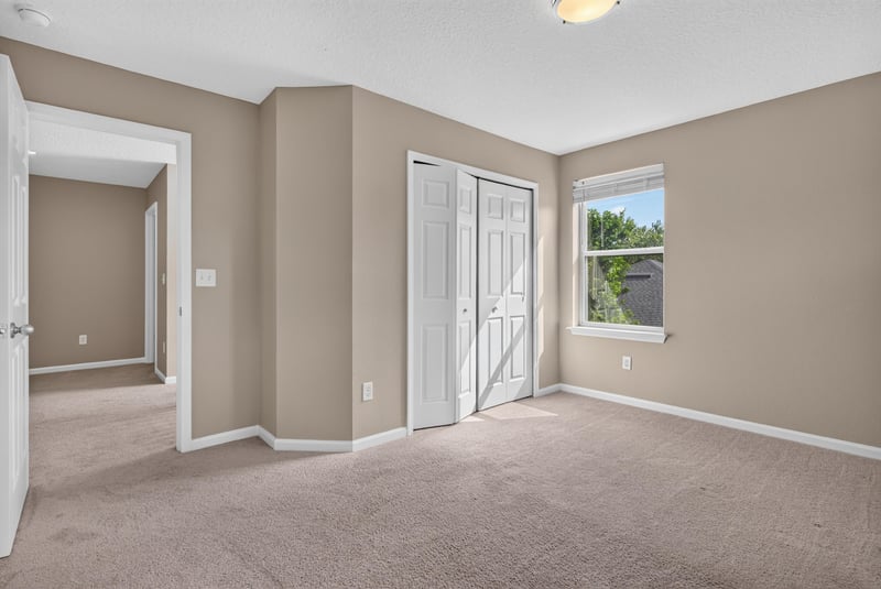 Bedroom with carpet, closet doors and window at 13685 Goodson Pl, Jacksonville, FL 32226