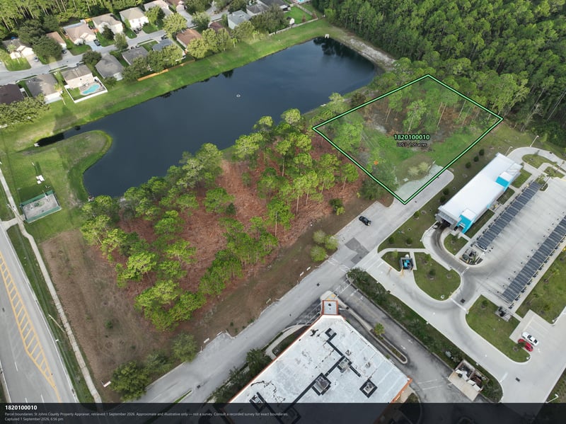 Aerial view of the pond, parking lot, and solar carport at 4900 US-1, St. Augustine, FL 32086