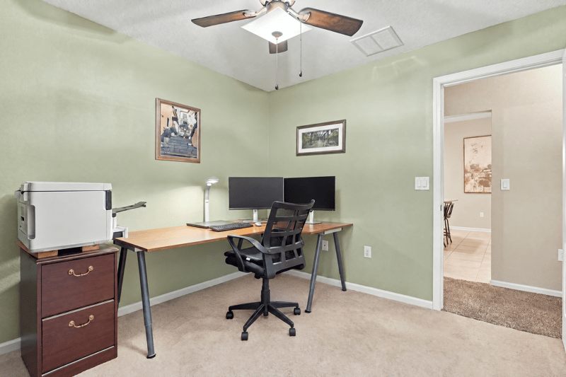 Home office with desk and monitors at 10923 Black Diamond Ct, Jacksonville, FL
